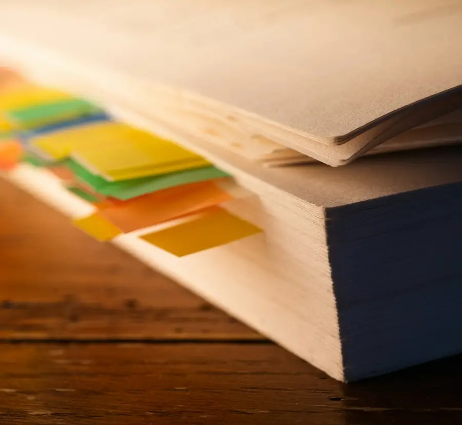 Book marked with colored sticky tabs